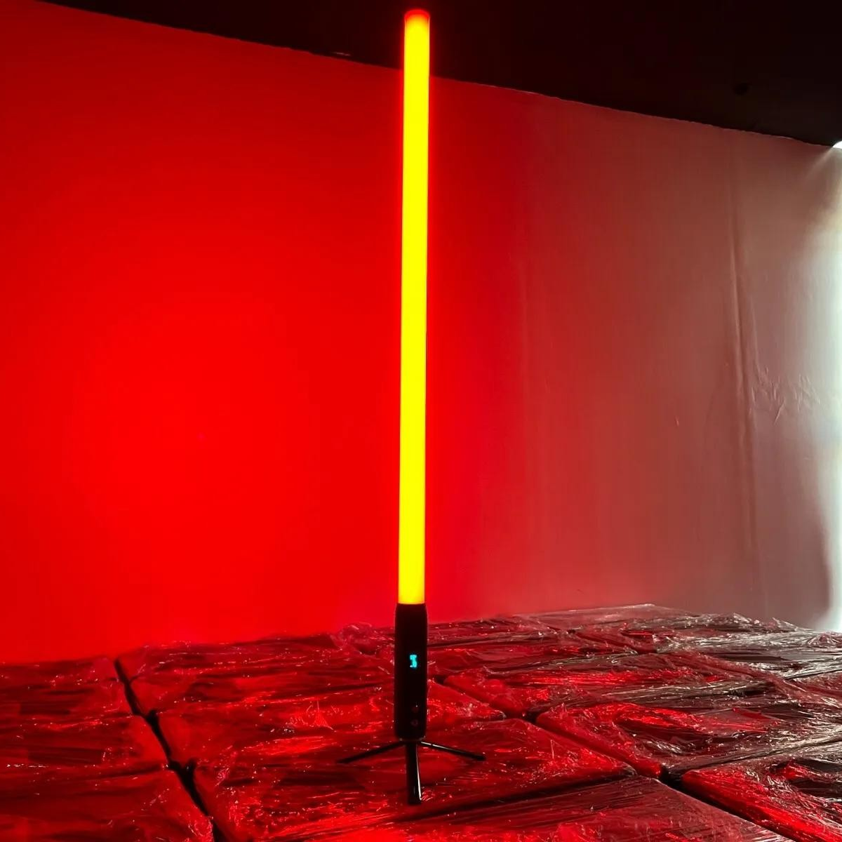 It features 192 RGBWA LEDs for full-color 360° illumination, with an IP65-rated aluminum housing, 9600mAh battery, wireless DMX control, and OLED display for versatile outdoor lighting setups. About 1.5 meters (59" inches) tall. Resembles a lightsaber.