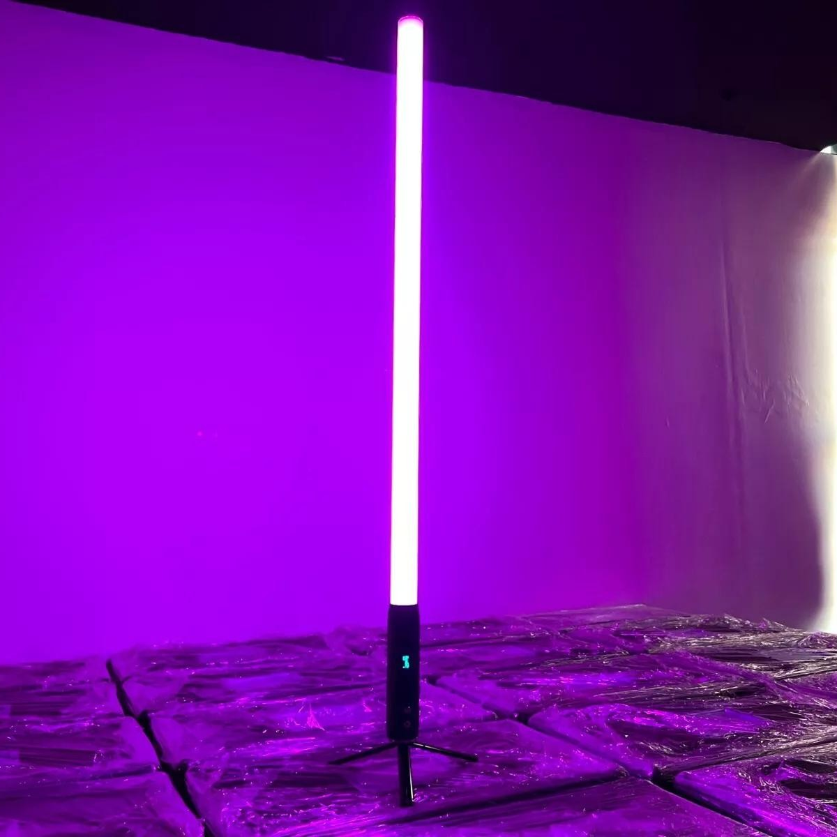 It features 192 RGBWA LEDs for full-color 360° illumination, with an IP65-rated aluminum housing, 9600mAh battery, wireless DMX control, and OLED display for versatile outdoor lighting setups. About 1.5 meters (59" inches) tall. Resembles a lightsaber.