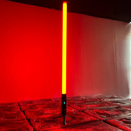 It features 192 RGBWA LEDs for full-color 360° illumination, with an IP65-rated aluminum housing, 9600mAh battery, wireless DMX control, and OLED display for versatile outdoor lighting setups. About 1.5 meters (59" inches) tall. Resembles a lightsaber.